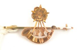 A 9ct gold sweetheart tie pin of the 6th Bn The King’s (Liverpool Regt), a bugle surmounted by the