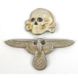 A Third Reich Waffen SS cap eagle and skull, with indistinct cast in markings, the eagle marked “