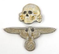 A Third Reich Waffen SS cap eagle and skull, with indistinct cast in markings, the eagle marked “