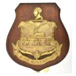 A cast brass badge of HMS Sir John Moore, monitor 1915-21 showing an ornamental shield with 2