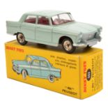 A French Dinky Toys Peugeot 404 (553). In very pale green with red interior, dished spun wheels