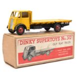 A Dinky Supertoys Guy Flat Truck (512). Example with yellow first type cab and body, black chassis