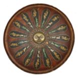 An Indian lacquered shield dhal. c.1900, 46cms, with central brass boss formed as a radiant sun,