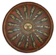 An Indian lacquered shield dhal. c.1900, 46cms, with central brass boss formed as a radiant sun,