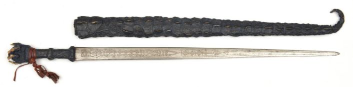A Sudanese short sword. Early 20th century, straight DE blade 61cms chiselled with geometric