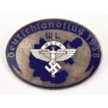 A Third Reich pin back oval silver plated and enamelled badge, in the centre the NSFK symbol in