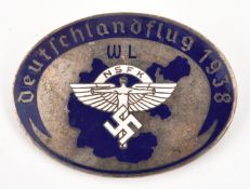 A Third Reich pin back oval silver plated and enamelled badge, in the centre the NSFK symbol in