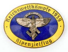 A Third Reich pin back oval enamelled badge, superimposed in the centre is the NSFK symbol on blue
