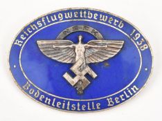 A Third Reich pin back oval silvered and blue enamelled badge, superimposed in the centre is the