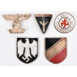 A Third Reich bar to the 1914 Ist Class Iron Cross; 2 metal shield badges for the tropical helmet;