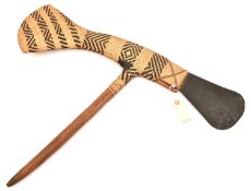 A Polynesian axe, grey stone head and long basket weave axe head shaped tail, 29" overall, on