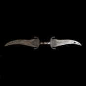 An Indian double-dagger haladie. Late 19th century twin opposed broad wavy-edge blades 27cms with