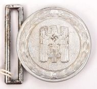 A Third Reich 1938 pattern Red Cross Leader's aluminium belt buckle, the back stamped "Ges. Gesch"