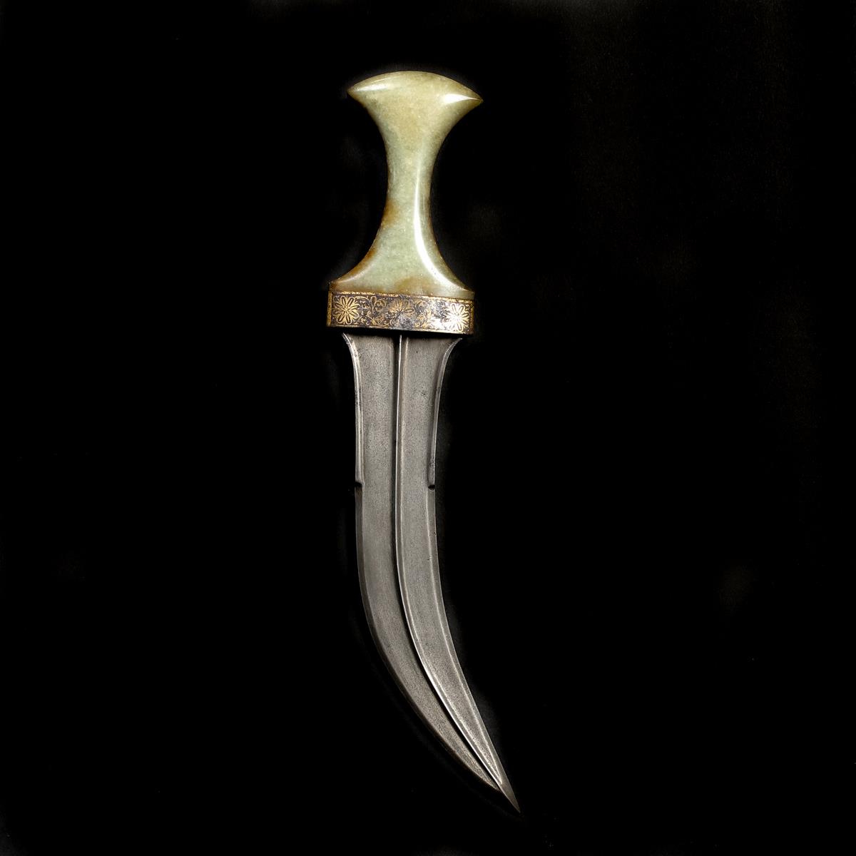 An Indian dagger jambiya. Late 19th century, broad curved wootz blade 20cms of Persian form