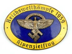 A Third Reich pin back oval enamelled badge, superimposed in the centre is the NSFK symbol on blue