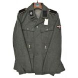 A Third Reich SS man's 4 pocket tunic, the right hand lining stamped with SS runes and "BW" in