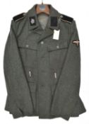 A Third Reich SS man's 4 pocket tunic, the right hand lining stamped with SS runes and "BW" in
