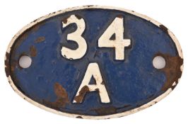 A cast iron locomotive shed plate for King's Cross, 34A. In 'as removed' condition, with white