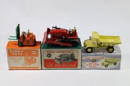 3 Dinky Toys. Blaw Knox Bulldozer (561) in red, example with black tracks. Plus a Euclid Dump