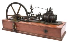 A single cylinder stationary engine of freelance design mounted on a mahogany base. Features