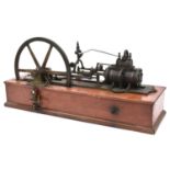 A single cylinder stationary engine of freelance design mounted on a mahogany base. Features