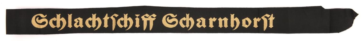 A German woven naval cap tally "Schlachtschiff Scharnhorst", yellow/gold lettering. GC (slightly