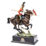 A Stadden figure of a mounted Trooper of the 16th Queen's Lancers, carrying lance, mounted on a