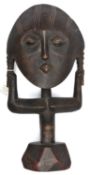 An African stylized darkwood female figure, ovoid face with short pigtails clasped by outstretched