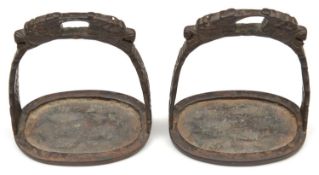 A pair of Chinese cast steel stirrups. 20th century, 14cms, bows each with a pair of dragon heads