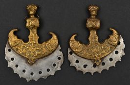 A pair of decorative Indian axe heads. 8cms, cast and pierced serrated steel blades, cast brass