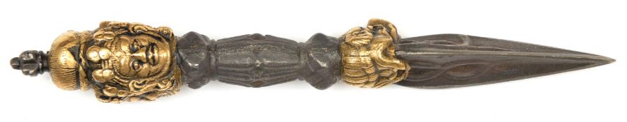 A cast iron Tibetan exorcizing dagger phurbu. 25cms, with 3 brass bodhisatva masks to the pommel,
