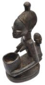 An African carved lightweight darkened wood figure of a mother with prominent features and child