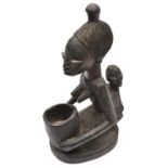 An African carved lightweight darkened wood figure of a mother with prominent features and child