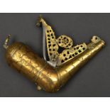 A Persian brass powder flask of horn shape. Late 19th century, 16cms, engraved with foliage overall,