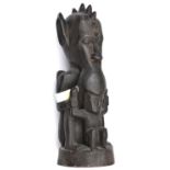 An African carved darkwood figure of a double deity, the top figure's head with pointed ears and row