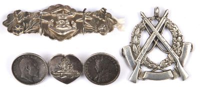 A heavy quality silver pendant, crossed rifles on wreath and blank scroll, engraved in caps on the