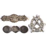 A heavy quality silver pendant, crossed rifles on wreath and blank scroll, engraved in caps on the