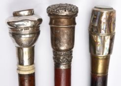 A stout polished brownwood walking cane, silver urn shaped grip with foliate embossed lower band and