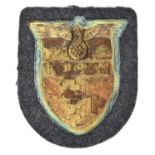 A Third Reich Kuban arm shield, on Luftwaffe grey/blue cloth patch with paper backing. GC,