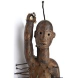 An interesting African witch doctor's darkwood, naked fetish figure, standing upright with the right