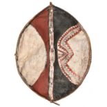 An African hide shield, of ovoid form, wooden frame with central grip, red, white and black (