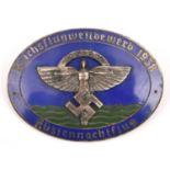 A Third Reich silvered and blue enamel oval pin back badge, superimposed in the centre is the NSFK