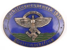 A Third Reich silvered and blue enamel oval pin back badge, superimposed in the centre is the NSFK