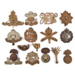 14 cap badges: RA, Welsh Gds, plastic Northumberland Fus (blades missing), Suffolk, Bedford (slide