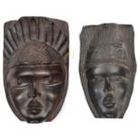 An African darkwood mask, female face with upright coiffure, cherubic features and eye slots, 12"