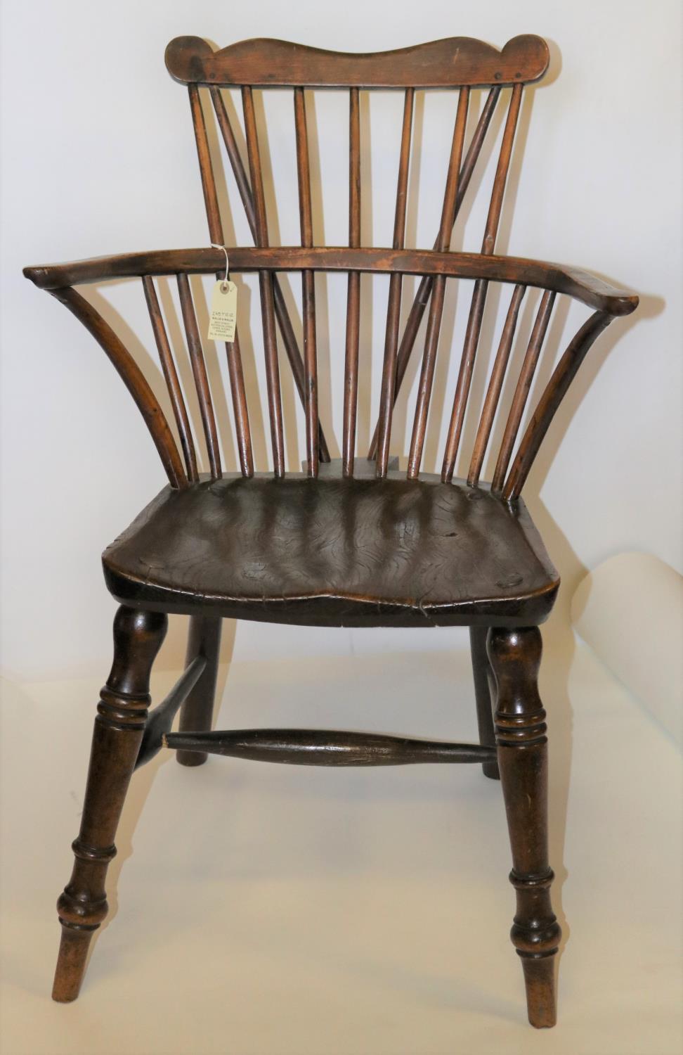 A 19th century comb back windsor chair in elm/yew. GC. £30-50