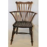A 19th century comb back windsor chair in elm/yew. GC. £30-50