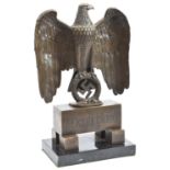 An impressive Third Reich desk ornament, in the form of a bronze eagle and swastika resting on an