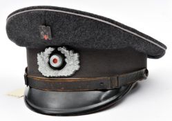 A Third Reich Red Cross NCO?s peaked cap, with light grey piping, dark grey band, aluminium cockade,