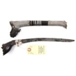 A Celebes knife, Bade Bade, forge welded blade 8" with plain silver mount and ferrule, the carved